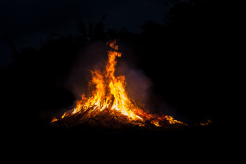 Bonfire blur silhouette Black background red light Powerful in the work, creative.