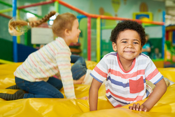 Wall Mural - colorful portrait of cute african-american boy smiling happily looking at camera while having fun in