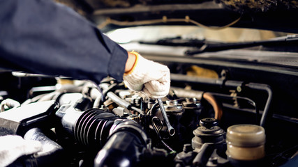 Auto mechanic Preparing For the work. Mechanic with Stainless Steel Wrench in Hand.Close up of hands mechanic doing car service and maintenance.