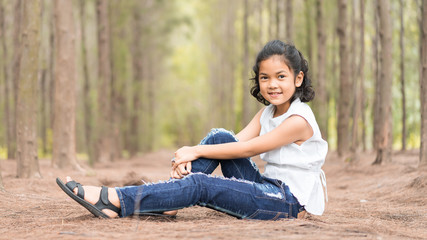 Happy asian children smiling relaxing on the grass,outdoors