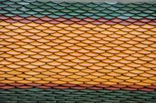 Close Up Image Of Orange, Red And Green Roof Tiles As Typically Found On Buddhist Temples Palaces In Thailand 