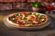Thin crust pizza with ham, cheese and olive.  Freshly baked pizza (from wood-fired oven).
