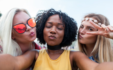 Selfie at summer music festival, group of friends having fun together