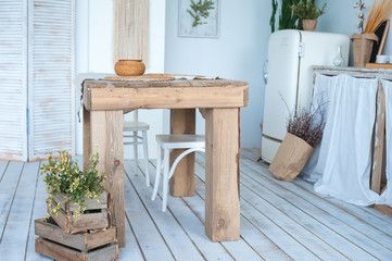 Wall Mural - White textured kitchen in the style of shabby. A large textured table in the ecological style and Loft style. Rustic wicker napkins, light green tablecloth, diy.