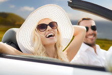 Road Trip, Travel And People Concept - Happy Couple Driving In Convertible Car Outdoors Over Big Sur Coast Of California Background