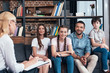 © LIGHTFIELD STUDIOS - smiling family on therapy session by female counselor writing in clipboard in office