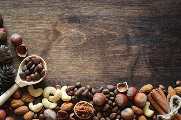 Different nuts on a wooden table. Cedar, cashew, hazelnut, walnu