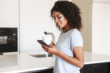 Happy african woman using mobile phone