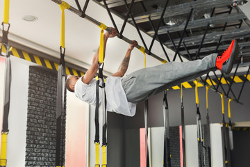 Wall Mural - Man doing pull up exercise on horizontal bar