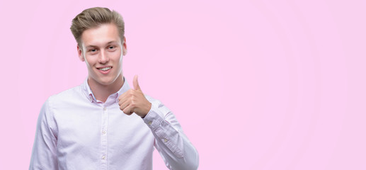 Sticker - Young handsome blond man happy with big smile doing ok sign, thumb up with fingers, excellent sign