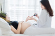 © chompoo - Female Obstetrician doctor  measuring blood sugar of the pregnant woman in the hospital. Gestational diabetes  mellitus concept.