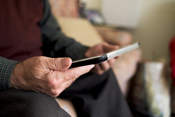 Wall Mural - old caucasian man using a tablet