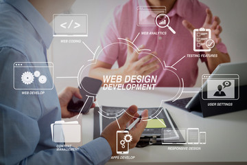 Businessmen working together on a document and using smart phone and digital tablet and laptop computer in modern office