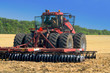 red tractor for harvesting in the midst of the summer season, produces disk field