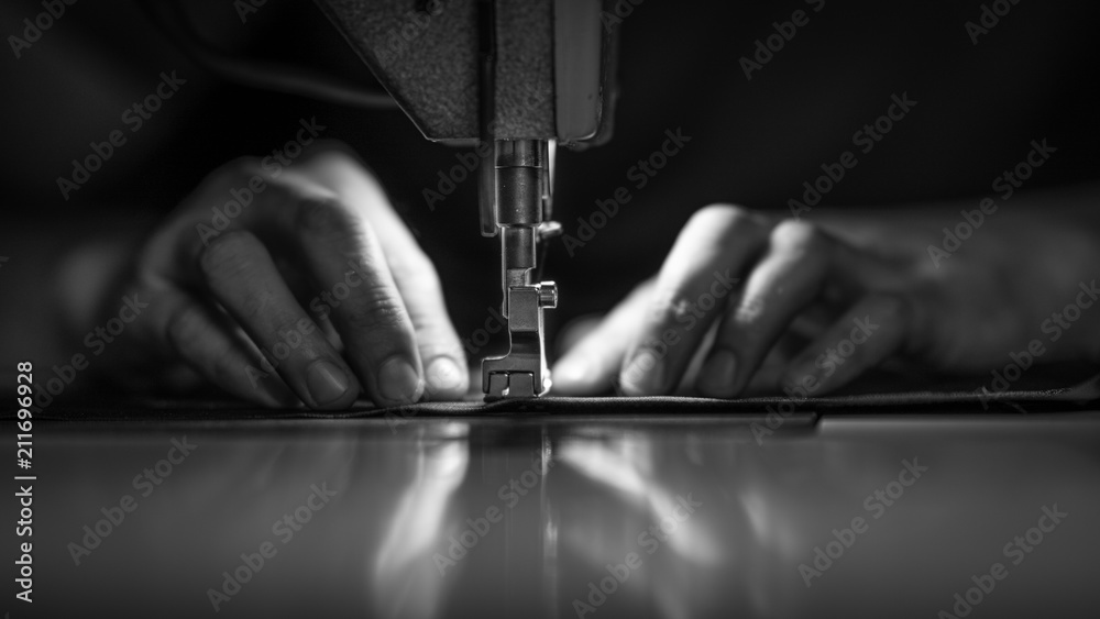 a man at work on a sewing machine. without a face. - obrazy, fototapety, plakaty 