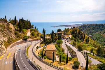 Narrow Italian streets down the mountain by the sea on Sicily island.