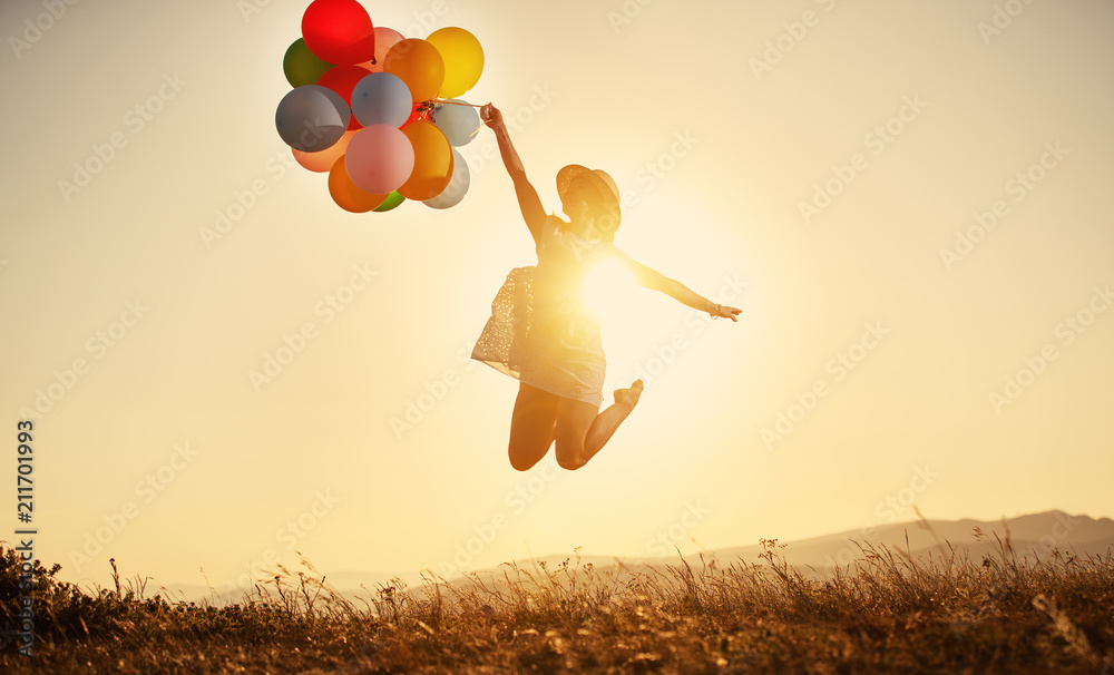 happy woman with balloons at sunset in summer - obrazy, fototapety, plakaty 