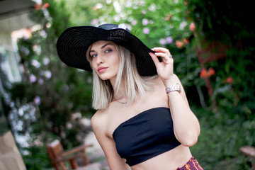 Fashion portrait of elegance stylish smiling and laughing young woman in hat and sunglasses walk on the street and posing on camera, emotions