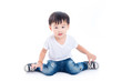 © gamelover - Little asian boy sitting on the floor and smiles over white background