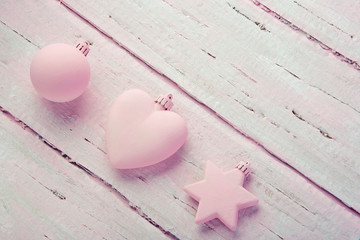 Wall Mural - New Year's Christmas toys, heart, star and ball on a beautiful pink table