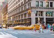 People and taxis in the intersection of Fifth Avenue and 23rd Street in Manhattan New York City