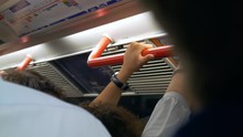 People Holding Handrail London Subway