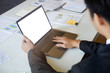 © Prathankarnpap - Businessman using Mock up Laptop with empty screen.