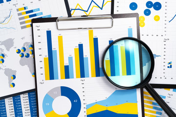 Poster - Analyzing marketing reports. Gathering statistical data.Pile of reports. Many charts and magnifying glass.
