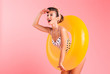 © Drobot Dean - Gorgeous young pin-up woman in swimwear with inflatable ring. Looking aside.