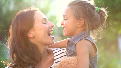 Fototapete - Beautiful mother and her little daughter playing in summer park together. Slow motion 4K UHD video 3840X2160