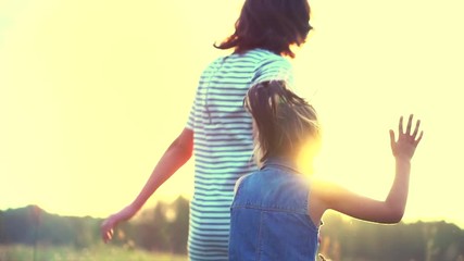 Fototapete - Happy mother and her daughter having fun outdoors. Slow motion. 4K UHD video 3840x2160