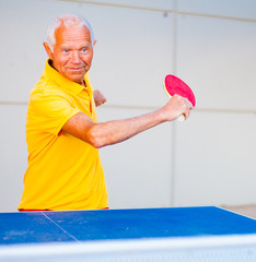 mature man playing table tennis