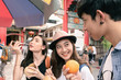 © Success Media - Group of young tourist drinking fresh fruit juice on a street at china town bangkok,Thailand