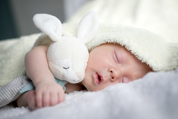 newborn baby boy portrait on white carpet closeup. motherhood and new life concept