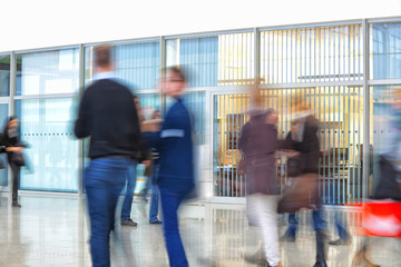 silhouettes of people walking in office building