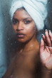 © Kike Arnaiz/ADDICTIVE STOCK - Alluring woman behind steamy shower glass