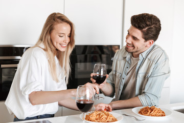 Wall Mural - Loving couple in kitchen have a dinner