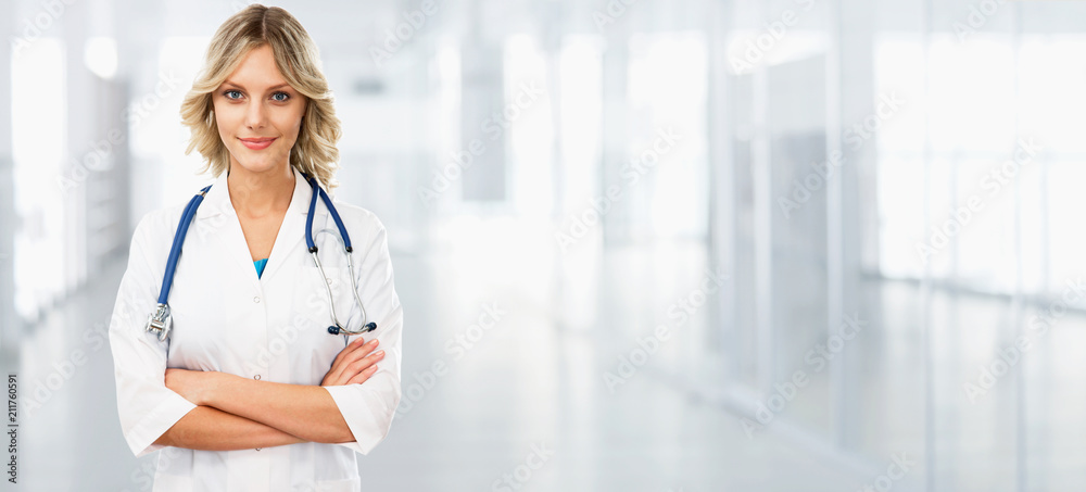 Young female doctor on modern clinic background. - obrazy, fototapety, plakaty 