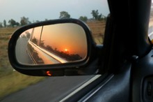 Beautiful View Of Morning Sunlight Reflection In Sideview Mirror Of Car On Country Road. Transportation, Journey And Travel Concept.