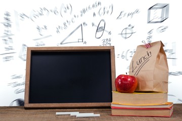 Poster - Slate with chalks by lunch bag and books on wooden table