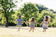 © Photocreo Bednarek - Three little children running on a green field