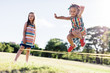 © Photocreo Bednarek - Little girl in a colorful dress jumping through the elastic.