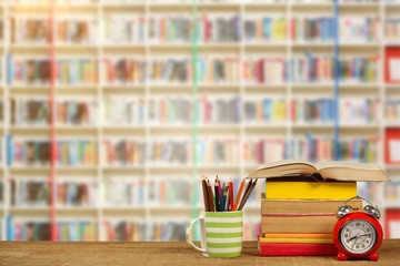 Poster - Composite image of stack of books by mug with colored pencils