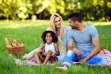 Wall Mural - Picture of lovely couple with their daughter having picnic