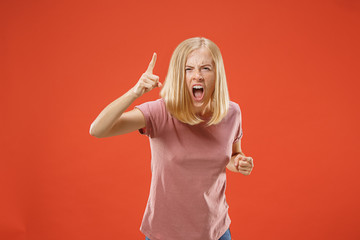 Wall Mural - Beautiful female half-length portrait isolated on red studio backgroud. The young emotional surprised woman