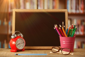 Poster - Composite image of slate with desk organizer and alarm clock by