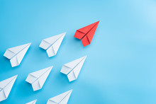 Leadership Concept With Red Paper Plane Leading Among White On Blue Background