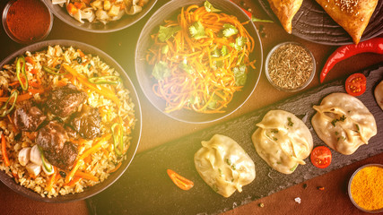 Assorted Uzbek food set, pilaf, samsa, lagman, manta and Korean carrots, Uzbek restaurant concept, Uzbek food feast