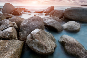 Seascape and rocks in sunset time.