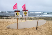 Flaged High Surf, Strong Curent Warning Signs With Rescue Surfboard Alone Tourest Island Beach Area